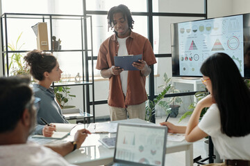 Team engaged in a financial presentation in a modern office setting