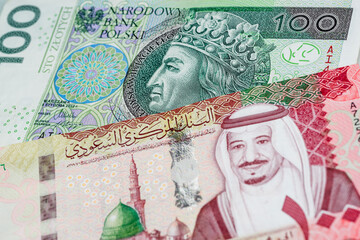 100 Polish zloty and 100 Saudi riyal banknotes. International trade concept