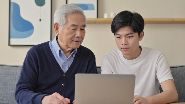 A father-son duo bonding over a laptop, possibly learning or gaming together