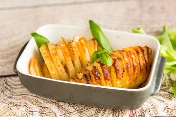Crispy baked potatoes in a country style