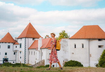 Beautiful woman walking of Varazdin streets during summer day in old, historical city center....