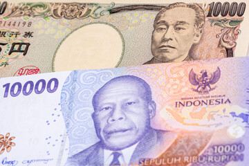 10000 Japanese yen and 10000 Indonesian rupee banknotes. International trade concept
