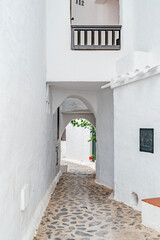 Narrow Whitewashed Alley With Archways in Binibeca Vell. Menorcan Coastal Village, Traditional Architecture, Cobblestone Street, Mediterranean Charm