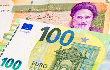 50000 Iranian rial and 100 Euro banknotes. International trade concept
