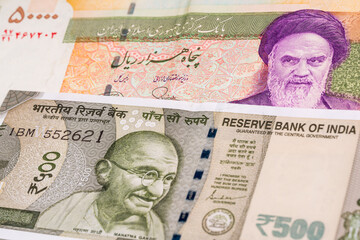 50000 Iranian rial and 500 Indian rupee banknotes. International trade concept