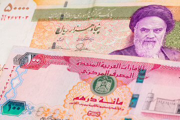 50000 Iranian rial and 100 United Arab Emirates dirham banknotes. International trade concept