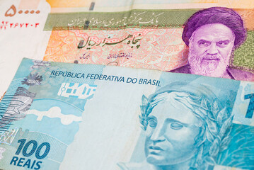 50000 Iranian rial and 100 Brazilian real banknotes. International trade concept