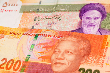 50000 Iranian rial and 200 South African rand banknotes. International trade concept