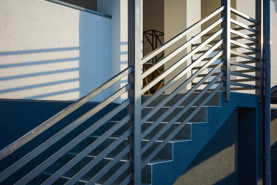 Modern metal railings and handrails in industrial style. The metal is treated with a primer and anti-corrosion paint.