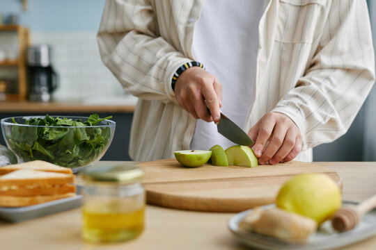 Person chopping fresh fruit in the kitchen
