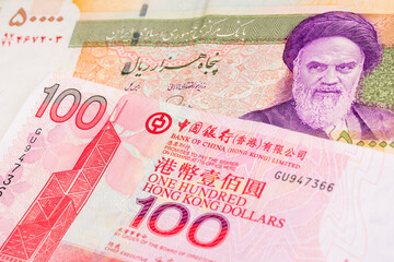 50000 Iranian rial and 100 Hong Kong dollar banknotes. International trade concept