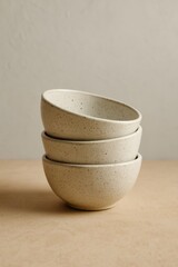 Three ceramic bowls, stacked elegantly on top of each other, captured with perfect lighting