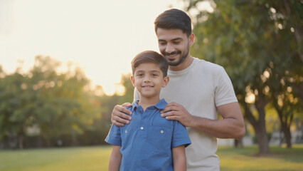 A father and son spending time together in a park, surrounded by nature