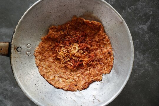 kerak telor or Egg Crust. kerak telor is Spicy Glutinous Rice Omelette with Grated Coconut. made from glutinous rice cooked, egg, serundeng, fried shallots and dried shrimp topping.