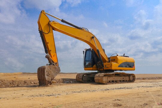 excavator or backhoe on construction site and sky background