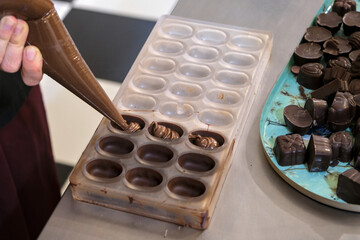 Workshop to create a chocolate plaque and filled chocolates. Poaching filled chocolates