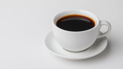 Obraz premium A white coffee cup filled with dark coffee sits on a matching saucer against a minimalistic backdrop, This image is ideal for cafe menus, food blogs, or articles about coffee culture,