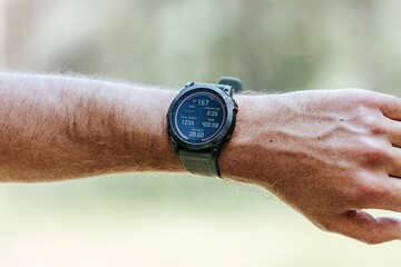 Smartwatch displaying fitness data outdoors.