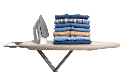An iron rests on an ironing board next to a neatly stacked pile of folded jeans in various shades of blue and brown.