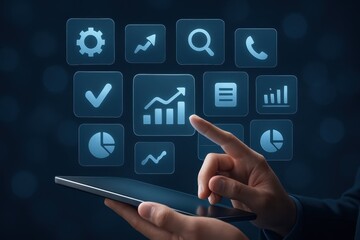 Hand interacting with a digital tablet displaying business analytics icons.