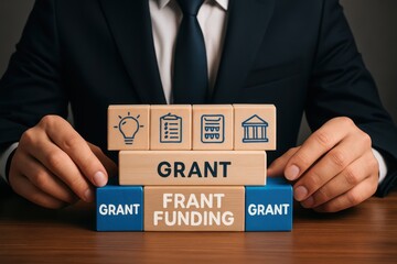 Wooden blocks arranged to illustrate grant funding.