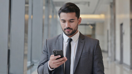 Fototapeta premium A man is focused on his cell phone
