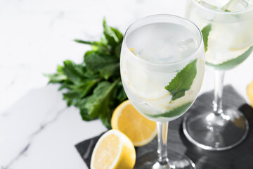 Hugo Spritz cocktail in glass on white marble background. Copy space