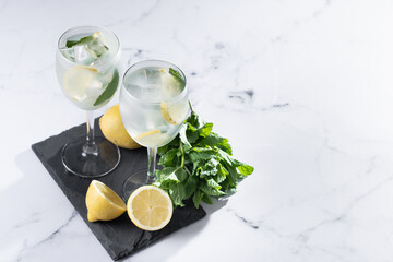 Hugo Spritz cocktail in glass on white marble background. Copy space