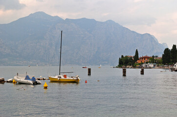 View of Lake Garda with Mountains Boats and Cloudy Sky 