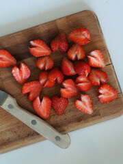 Strawberry dessert in the form of hearts on a cutting board