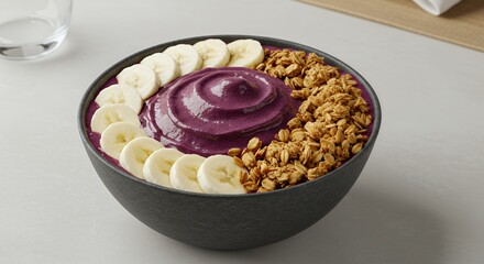 Indulge in this vibrant acai bowl, a symphony of creamy purple goodness topped with golden granola and perfectly sliced banana.
