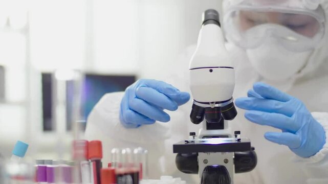 A scientist examines bone cells under a microscope, researching how broken bones heal to advance bone care and regeneration, in the medical field.