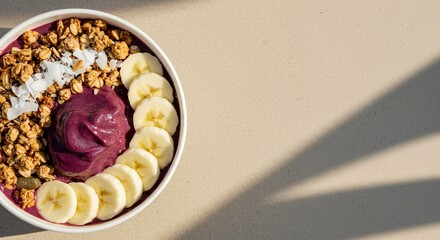 Indulge in a vibrant Acai bowl, bursting with granola, coconut flakes, and sliced bananas, a perfect summer treat bathed in sunlight.