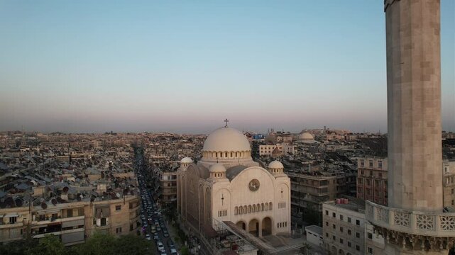 Drone view of a church next to a mosque in Aleppo, symbolizing peaceful coexistence in Syria