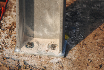 Close-up of holding down bolts used to secure steel frame structure into position