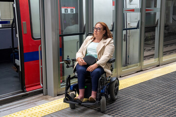 Businesswoman in wheelchair leaving accessible public transport train. Concept of inclusion, adapted