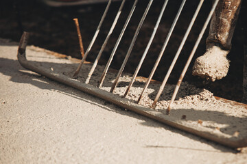 Close-up of Concreter leveling fresh concrete with screed dapple bar on building site