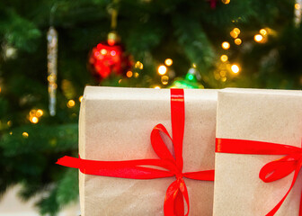 Close-up of New Year's gifts. Christmas tree in the background. New Year. Christmas. Gifts.