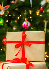 Close-up of New Year's gifts. Christmas tree in the background. New Year. Christmas. Gifts.
