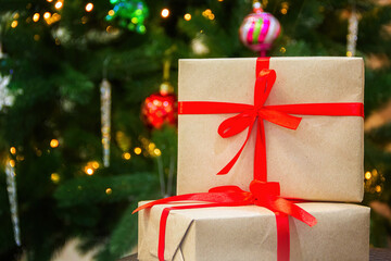 Close-up of New Year's gifts. Christmas tree in the background. New Year. Christmas. Gifts.