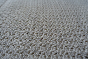 Close view of ivory white handmade crochet lacy fabric