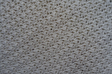 Texture of ivory white handmade crochet lacy fabric