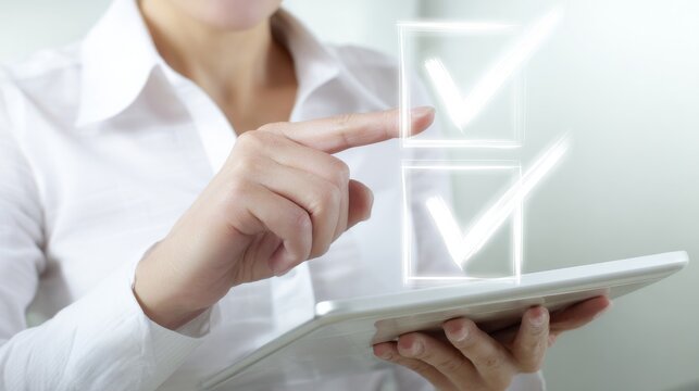 Person in white-collared shirt interacting with glowing white check-box icons using a sleek white tablet in a neutral, blurred background setting.