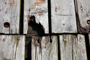A small hole in the wooden bridge