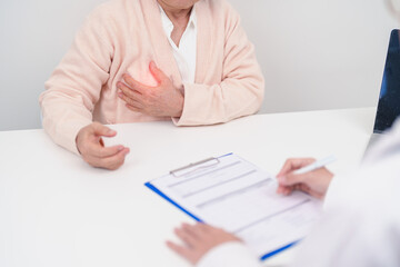 Elderly woman Patient consultation with doctor for Breast Augmentation Surgery, October Breast Cancer Awareness month, implant, Diagnosis, Beauty woman enlargement and medical healthcare concept