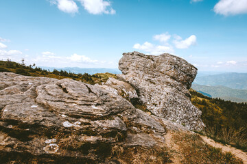  Stone mountain peak in the Carpathian Mountains. A massive rock is visible in the foreground....