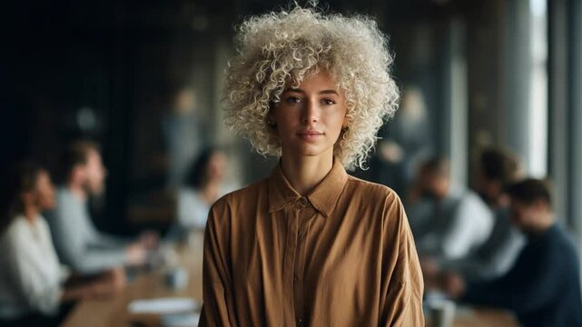 Confidence in Command: A striking woman of European descent with an afro, exuding professional confidence, stands at the heart of a modern business setting. Embodying poise and self-assurance.