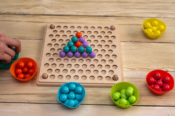 a children's game that develops fine motor skills and logical thinking in children according to the Montessori system.