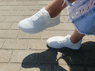 Women white summer sneakers. Lightweight women shoes,woven sneakers on woman.