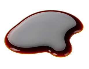 Glossy liquid sauce on a white surface.